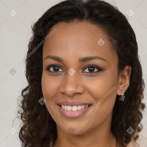 Joyful black young-adult female with long  brown hair and brown eyes