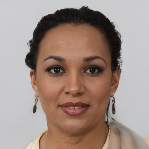 Joyful latino adult female with short  brown hair and brown eyes