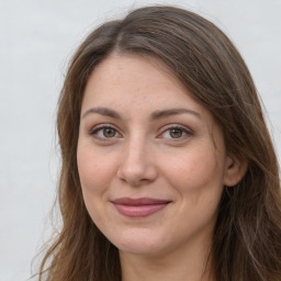 Joyful white adult female with long  brown hair and brown eyes