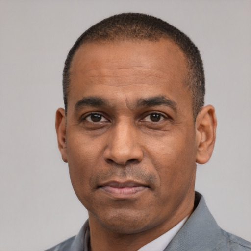 Neutral latino adult male with short  black hair and brown eyes