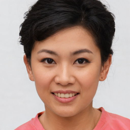 Joyful asian young-adult female with short  brown hair and brown eyes