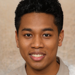 Joyful black young-adult male with short  black hair and brown eyes