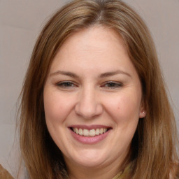 Joyful white adult female with long  brown hair and brown eyes