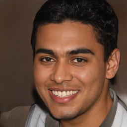 Joyful latino young-adult male with short  brown hair and brown eyes