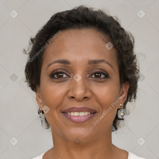 Joyful black adult female with short  brown hair and brown eyes