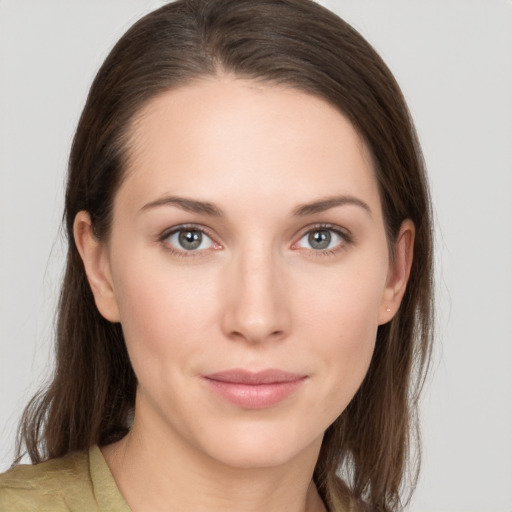 Joyful white young-adult female with medium  brown hair and grey eyes