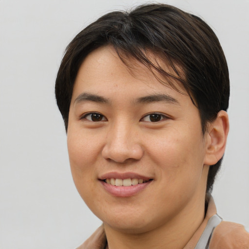 Joyful asian young-adult female with short  brown hair and brown eyes