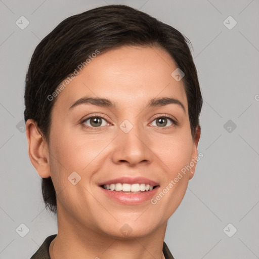 Joyful white young-adult female with short  brown hair and brown eyes