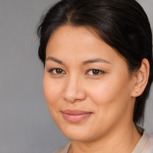 Joyful asian young-adult female with medium  brown hair and brown eyes