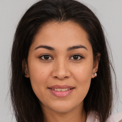 Joyful white young-adult female with long  brown hair and brown eyes