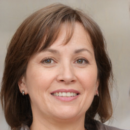 Joyful white adult female with medium  brown hair and grey eyes