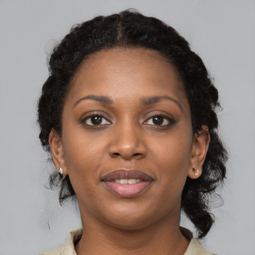 Joyful black young-adult female with medium  black hair and brown eyes