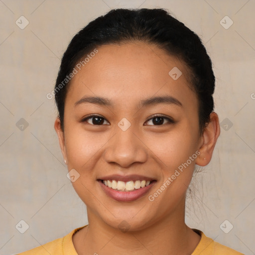 Joyful latino young-adult female with short  black hair and brown eyes