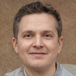 Joyful white adult male with short  brown hair and brown eyes