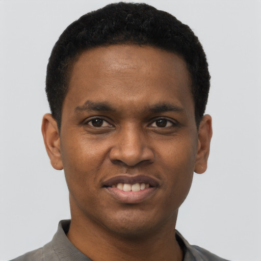 Joyful black young-adult male with short  black hair and brown eyes