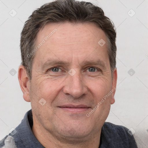 Joyful white adult male with short  brown hair and grey eyes