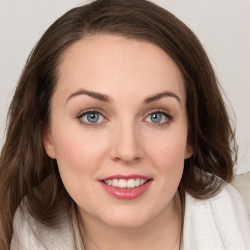 Joyful white young-adult female with long  brown hair and grey eyes