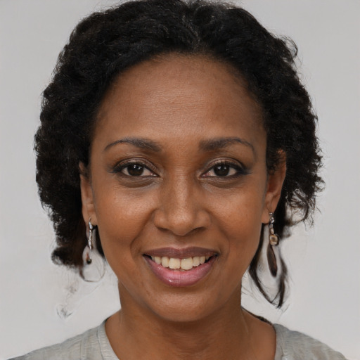 Joyful black adult female with short  brown hair and brown eyes