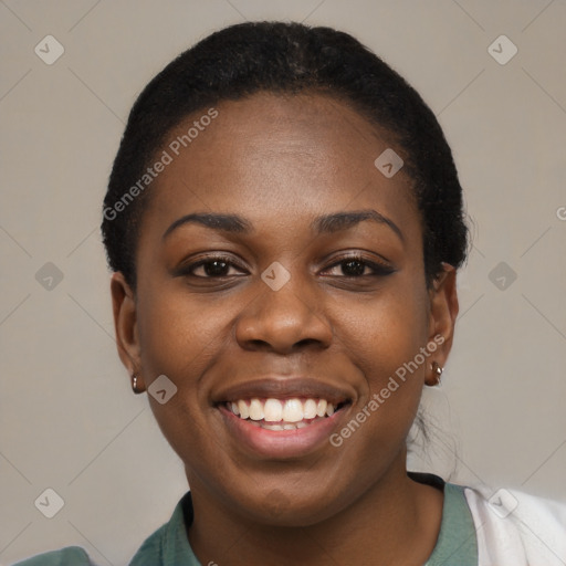 Joyful black young-adult female with short  black hair and brown eyes