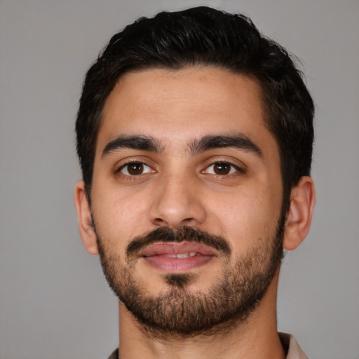 Joyful latino young-adult male with short  black hair and brown eyes