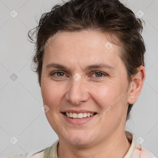 Joyful white adult female with short  brown hair and brown eyes