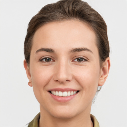 Joyful white young-adult female with short  brown hair and grey eyes