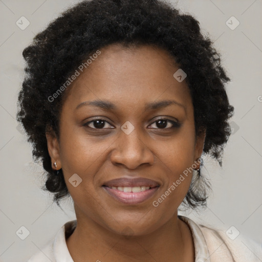 Joyful black adult female with short  brown hair and brown eyes