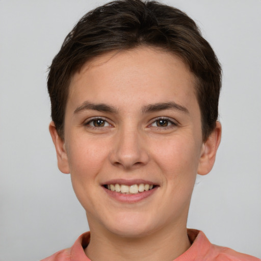 Joyful white young-adult female with short  brown hair and grey eyes