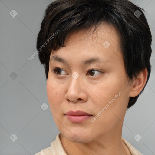 Joyful asian young-adult female with short  brown hair and brown eyes