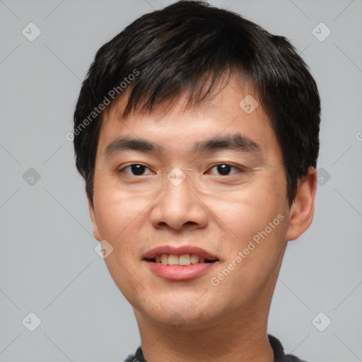 Joyful asian young-adult male with short  black hair and brown eyes