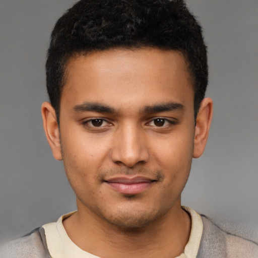 Joyful latino young-adult male with short  brown hair and brown eyes