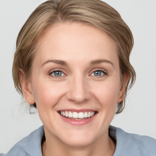 Joyful white young-adult female with medium  brown hair and blue eyes