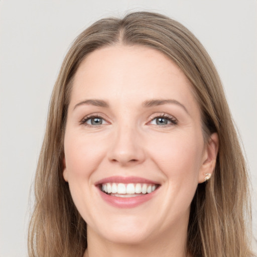 Joyful white young-adult female with long  brown hair and grey eyes