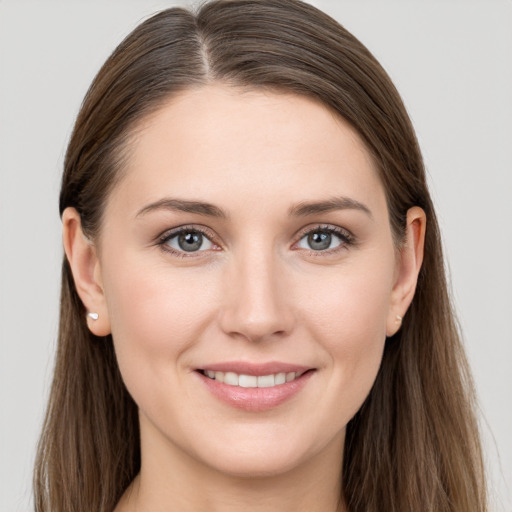 Joyful white young-adult female with long  brown hair and grey eyes