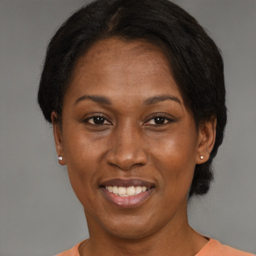 Joyful black adult female with short  brown hair and brown eyes
