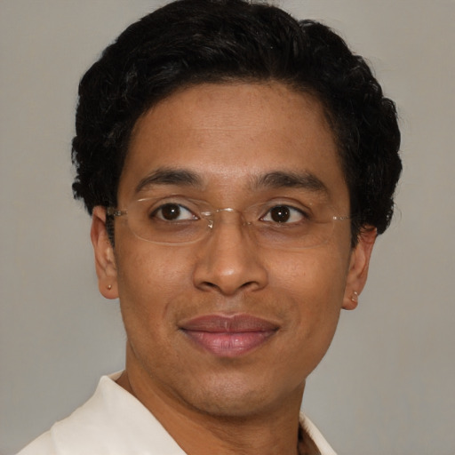 Joyful black young-adult male with short  brown hair and brown eyes