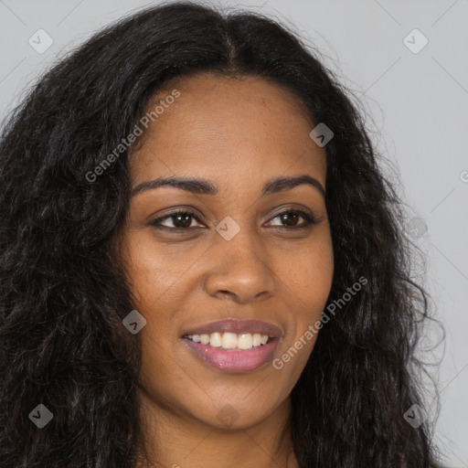 Joyful black young-adult female with long  brown hair and brown eyes