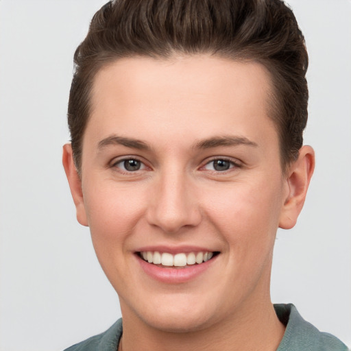 Joyful white young-adult female with short  brown hair and grey eyes