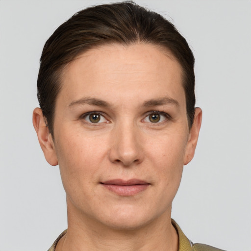 Joyful white young-adult female with short  brown hair and grey eyes