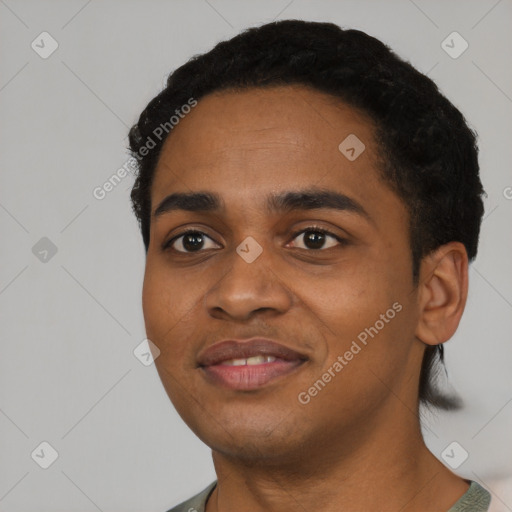 Joyful black young-adult male with short  black hair and brown eyes