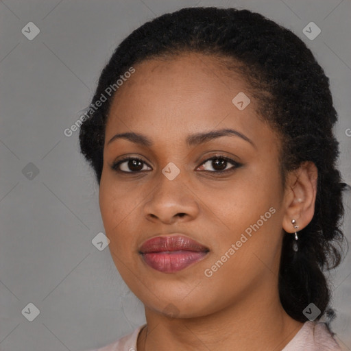 Joyful black young-adult female with long  brown hair and brown eyes