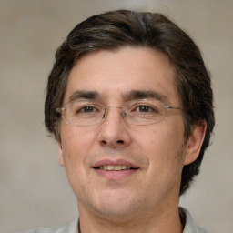 Joyful white adult male with short  brown hair and brown eyes