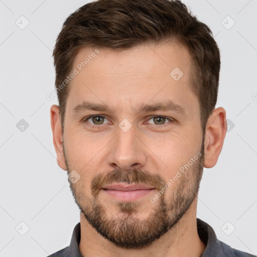 Joyful white adult male with short  brown hair and brown eyes