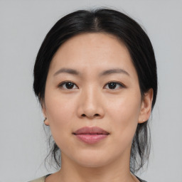 Joyful asian young-adult female with medium  black hair and brown eyes