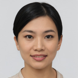 Joyful asian young-adult female with short  black hair and brown eyes