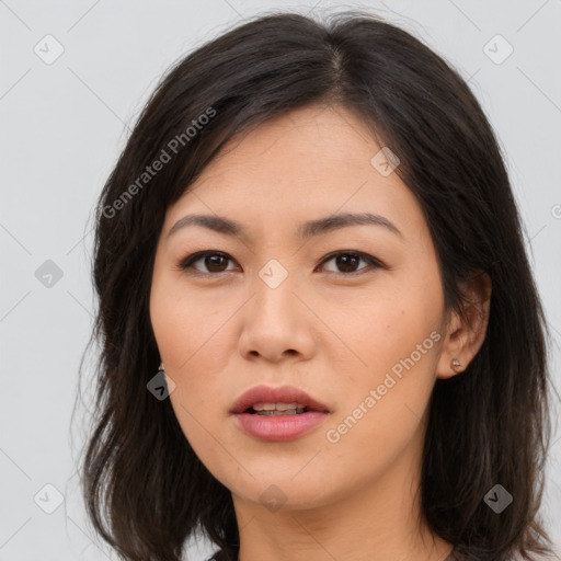 Joyful asian young-adult female with long  brown hair and brown eyes