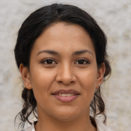 Joyful latino young-adult female with medium  brown hair and brown eyes