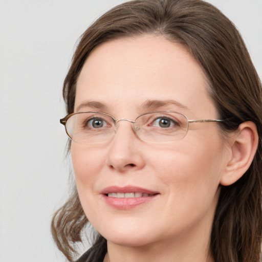 Joyful white adult female with long  brown hair and blue eyes