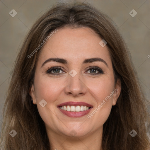 Joyful white adult female with long  brown hair and brown eyes