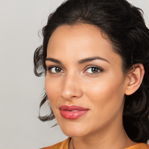 Joyful latino young-adult female with medium  brown hair and brown eyes